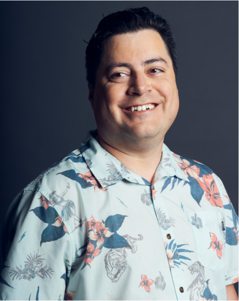 Jim Counts smiling in a floral shirt, friendly and professional headshot